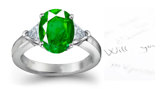 engagement ring three stone with oval emerald and side trillion diamonds