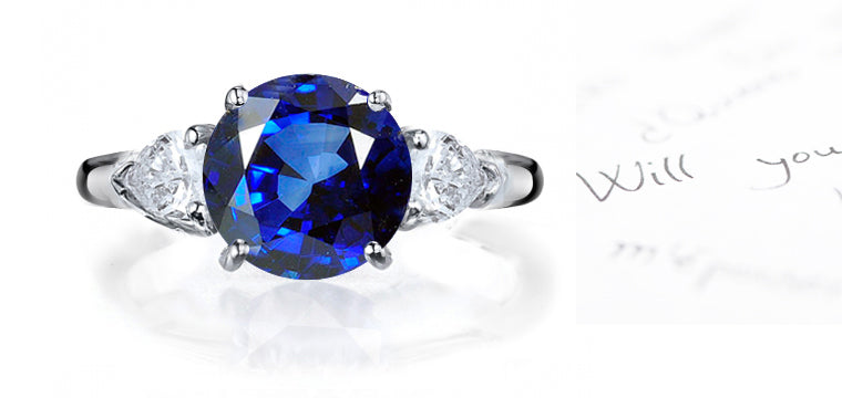engagement ring three stone with oval blue sapphire and side pear shape diamonds