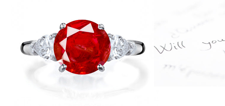 engagement ring with round ruby and side pear shaped diamonds