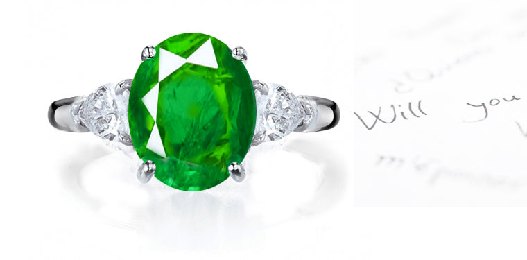 engagement ring three stone with round emerald and side pear shaped diamonds