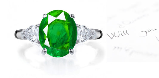 engagement ring three stone with round emerald and side pear shaped diamonds