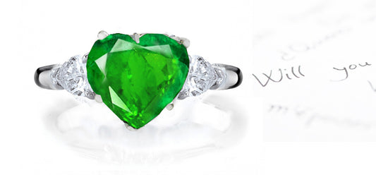 engagement ring three stone with heart emerald center and side pear diamonds