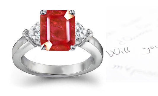engagement ring three stone with emerald cut ruby center and side trillion diamonds