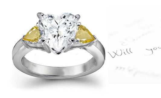 engagement ring with heart diamond center and side pear yellow sapphires