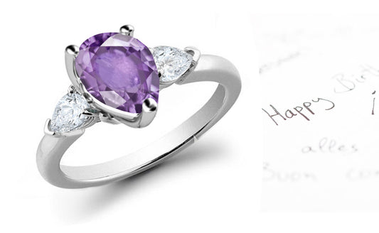 engagement ring with pear purple sapphire center stone and side pear diamonds