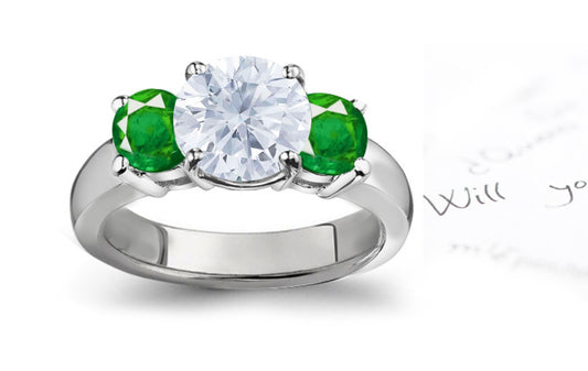 engagement ring three stone with round diamond and side round emeralds