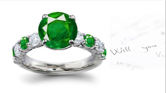 engagement ring with round emeralds and diamonds