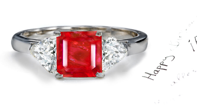 engagement ring three stone with square ruby center and side heart diamonds