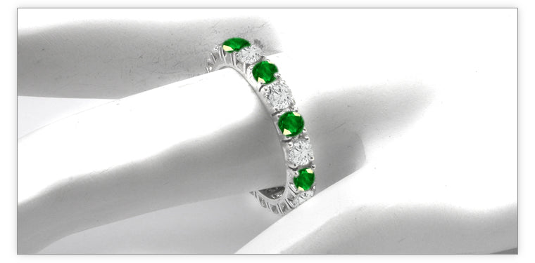 eternity ring prong set with round emeralds and diamonds