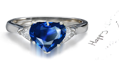 engagement ring three stone with heart blue sapphire center and side trillion diamonds