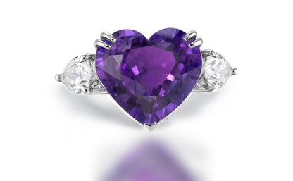 Custom made purple sapphire and diamond three stone engagement rings
