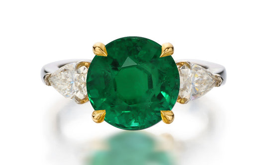 122 custom made unique round cut emerald center stone and pear cut diamond side three stone engagement ring