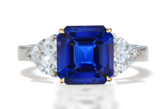 125 custom made unique asscher cut blue sapphire center stone and heart diamond side three stone engagement ring