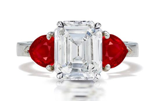 126 custom made unique emerald cut diamond center stone and heart ruby side three stone engagement ring