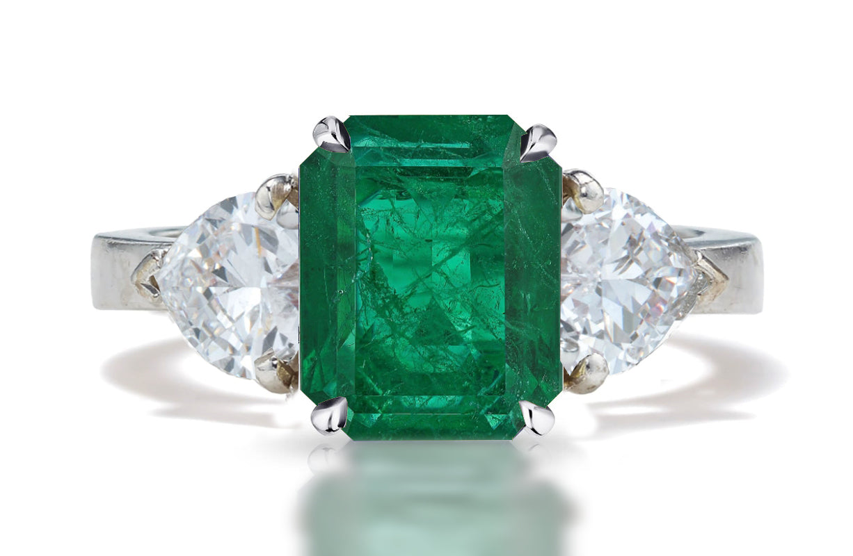 127 custom made unique emerald cut emerald center stone and heart diamond side three stone engagement ring