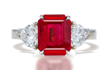 127 custom made unique emerald cut ruby center stone and heart diamond side three stone engagement ring