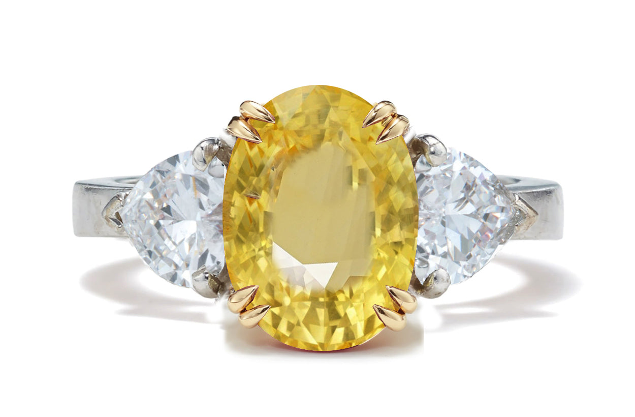 128 custom made unique oval cut yellow sapphire center stone and heart diamond side three stone engagement ring