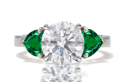 130 custom made unique diamond center stone and heart emerald side three stone engagement ring