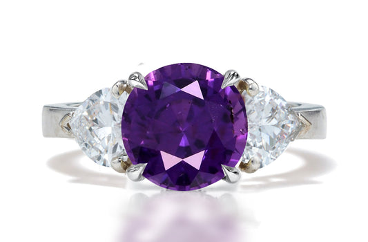 131 custom made unique round purple sapphire center stone and heart diamond side three stone engagement ring