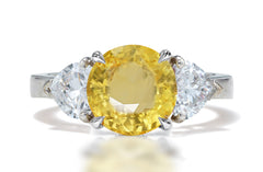 131 custom made unique round yellow sapphire center stone and heart diamond side three stone engagement ring