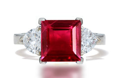 132 custom made unique square ruby center stone and heart diamond side three stone engagement ring