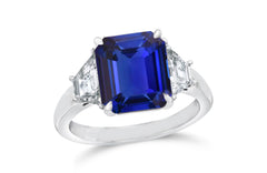 139 custom made unique emerald cut blue sapphire center stone and trapezoid side three stone engagement ring