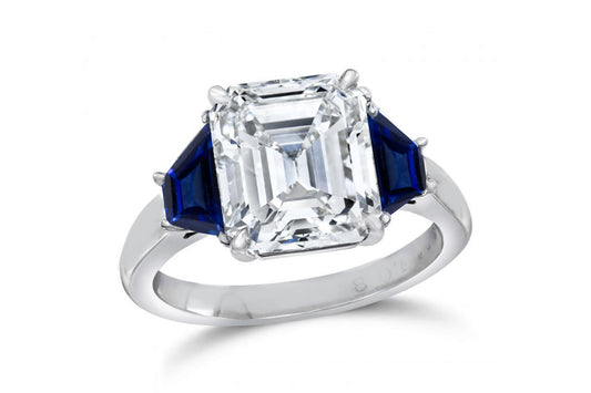 139 custom made unique emerald cut diamond center stone and trapezoid blue sapphire side three stone engagement ring