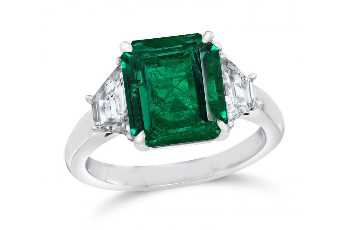 139 custom made unique emerald cut emerald center stone and trapezoid diamond side three stone engagement ring