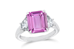 139 custom made unique emerald cut pink sapphire center stone and trapezoid diamond side three stone engagement ring