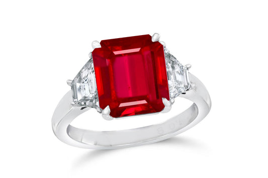 139 custom made unique emerald cut ruby center stone and trapezoid diamond side three stone engagement ring