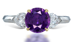 14 custom made unique round purple sapphire center stone with heart diamond accents three stone engagement ring