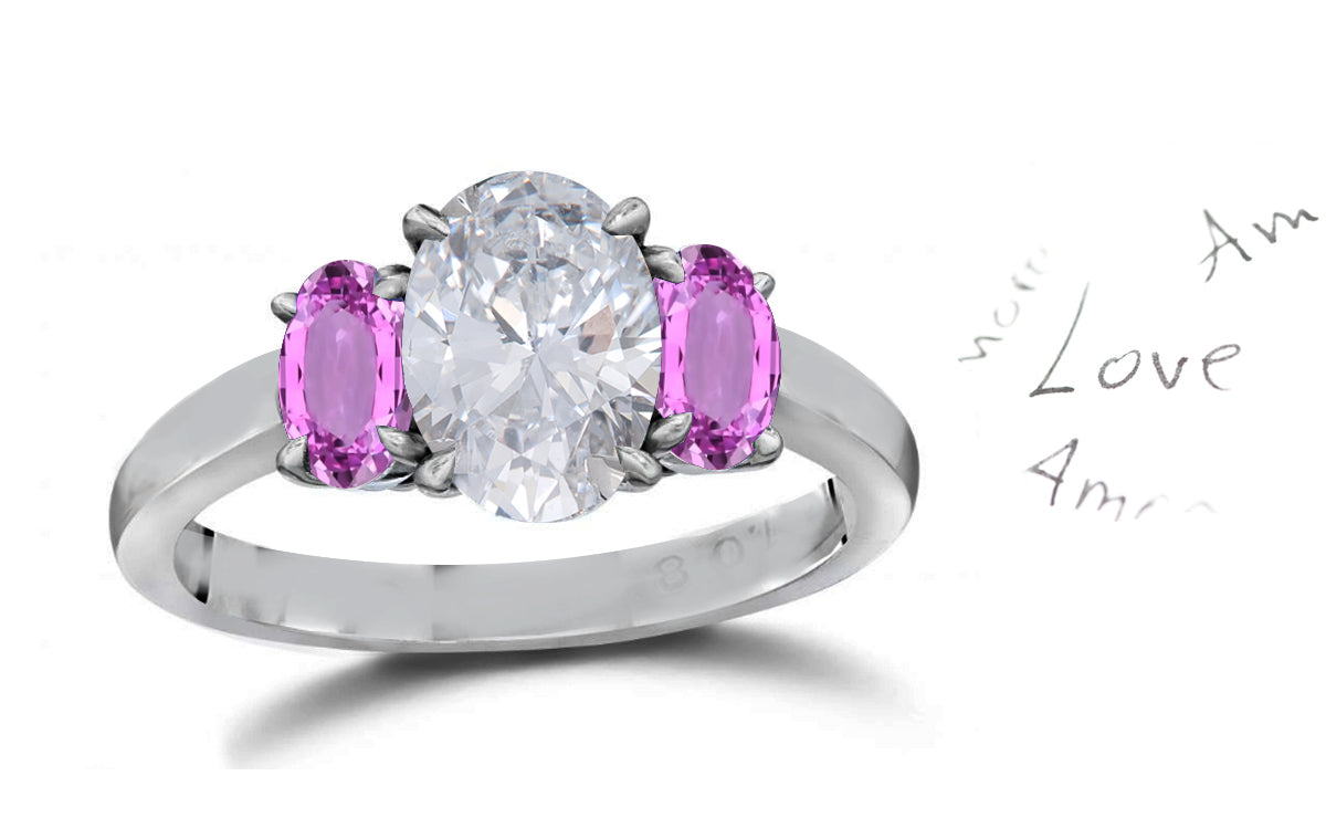 141 custom made unique oval diamond center stone and oval pink sapphire side three stone engagement ring