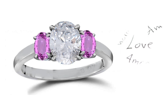 141 custom made unique oval diamond center stone and oval pink sapphire side three stone engagement ring