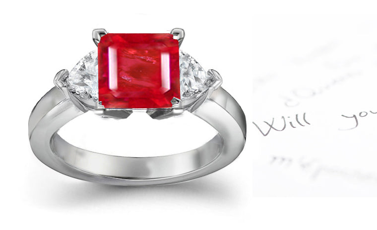 engagement ring three stone with square ruby center and side heart diamonds