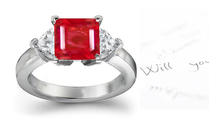 engagement ring three stone with square ruby center and side heart diamonds