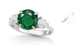 154 custom made unique round emerald center stone and round diamond accents three stone engagement ring