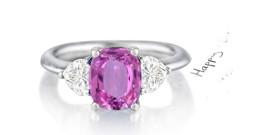 162 custom made unique oval pink sapphire center stone and heart diamond accents three stone engagement ring