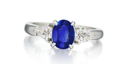 168 custom made unique oval blue sapphire center stone and pear diamond accents three stone engagement ring