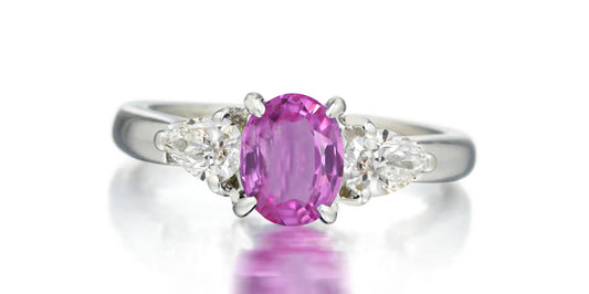 168 custom made unique oval pink sapphire center stone and pear diamond accents three stone engagement ring