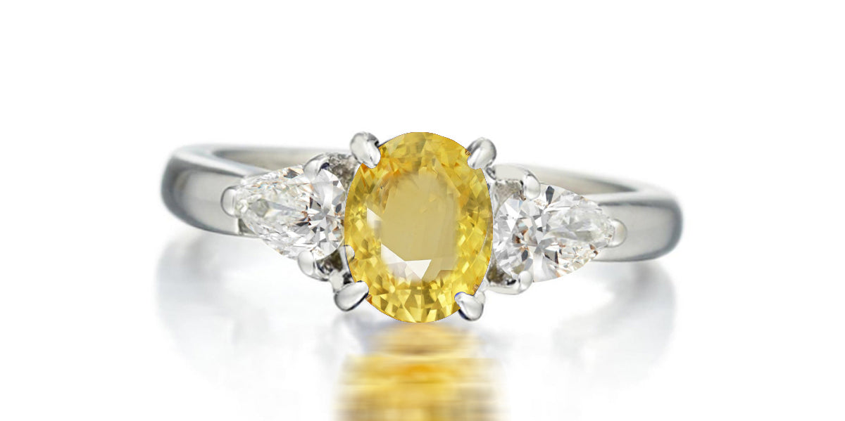 168 custom made unique oval yellow sapphire center stone and pear diamond accents three stone engagement ring.