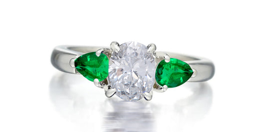 169 custom made unique oval diamond center stone and pear emerald accents three stone engagement ring