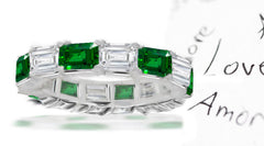 eternity ring with alternating baguette cut emeralds and diamonds