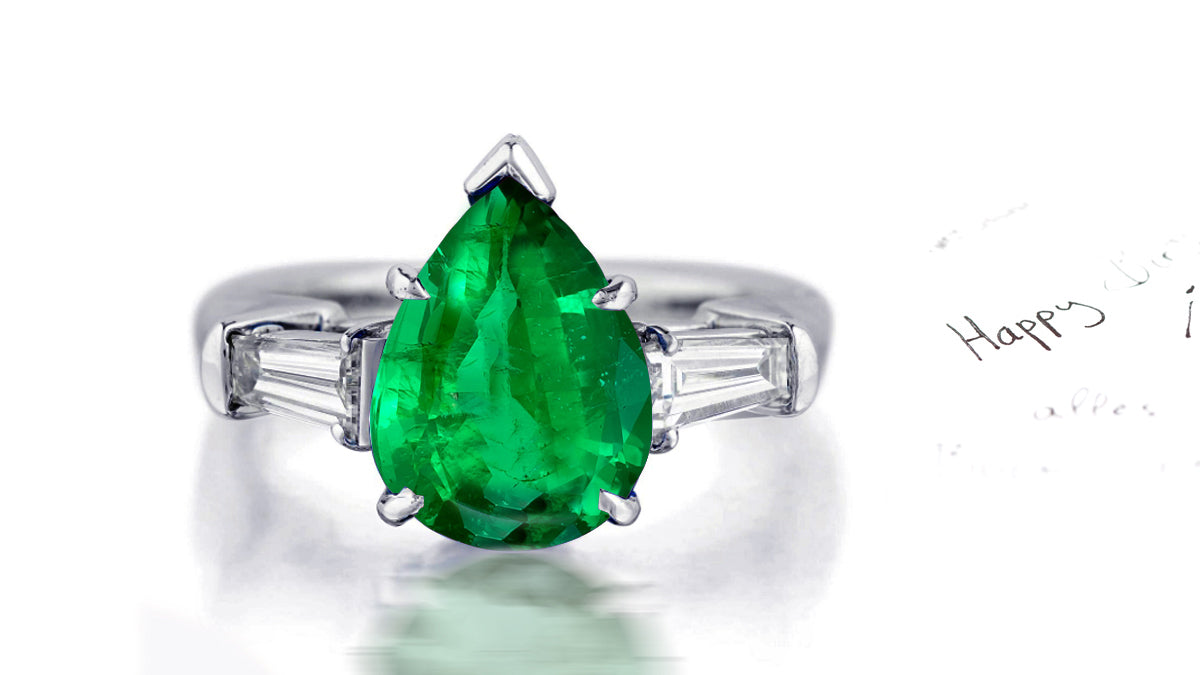 181 custom made unique pear cut emerald center stone and baguette cut diamond accents three stone engagement ring