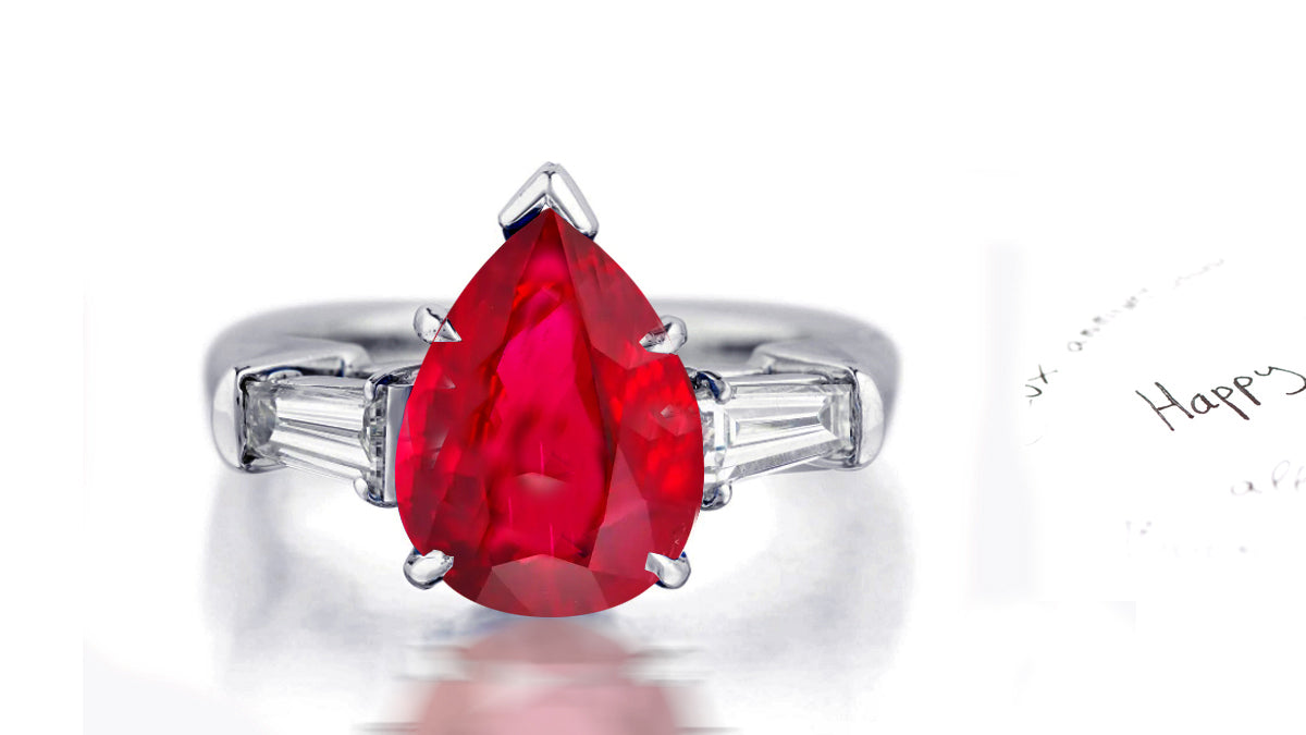 181 custom made unique pear cut ruby center stone and baguette cut diamond accents three stone engagement ring