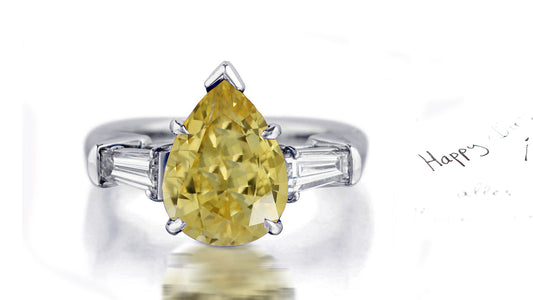 181 custom made unique pear cut yellow sapphire center stone and baguette cut diamond accents three stone engagement ring