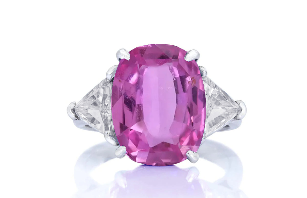 197 custom made unique oval pink sapphire center stone and trillion cut diamond accents three stone engagement ring