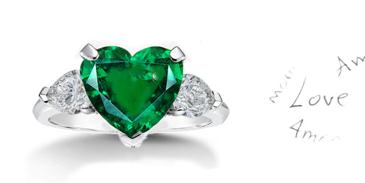 199 custom made unique heart emerald center stone and pear shaped diamond accents three stone engagement ring