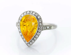 2 custom made yellow sapphire and diamond flower halo engagement rings