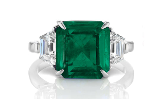 205 custom made unique asscher cut emerald center stone and trapezoid diamond side three stone engagement ring