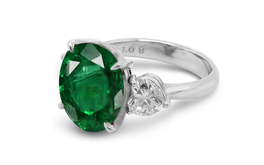 209 custom made unique oval cut emerald center stone and heart diamond side three stone engagement ring